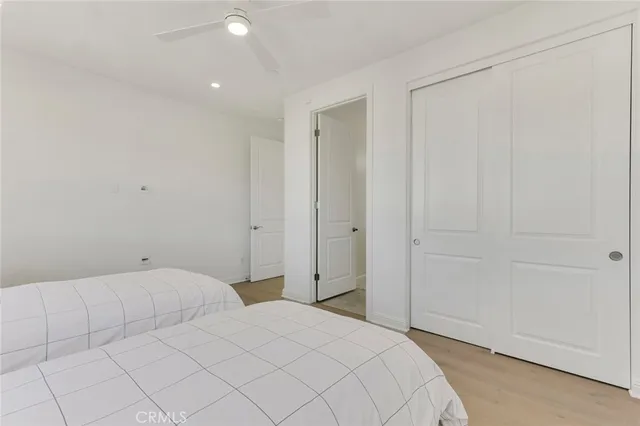 a bathroom with a toilet a sink a mirror a shower and vanity