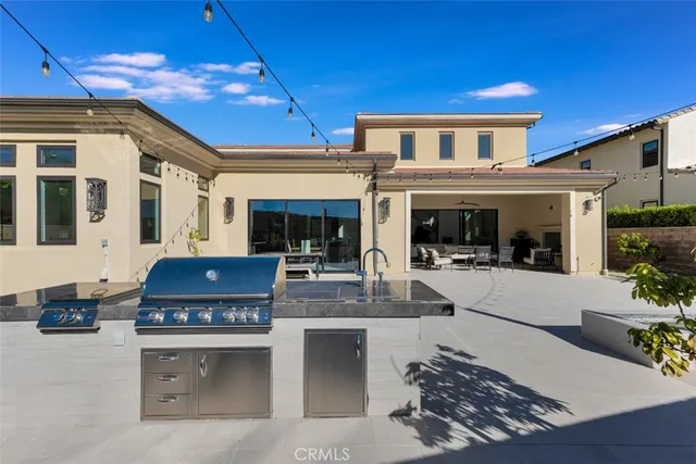 a view of a patio with couches table and chairs with plants and lake view