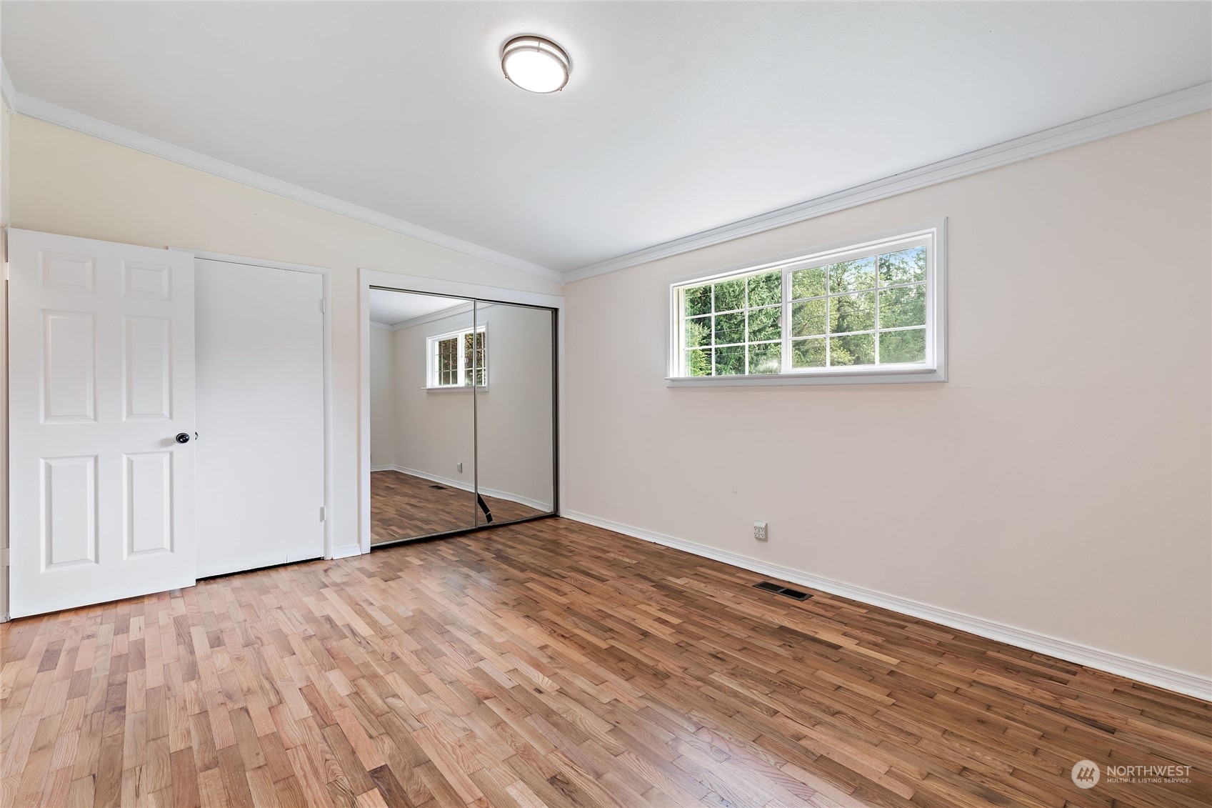 13207 178th Avenue Southeast Renton, WA 98059 - Photo 11 of 15 an empty room with wooden floor and windows