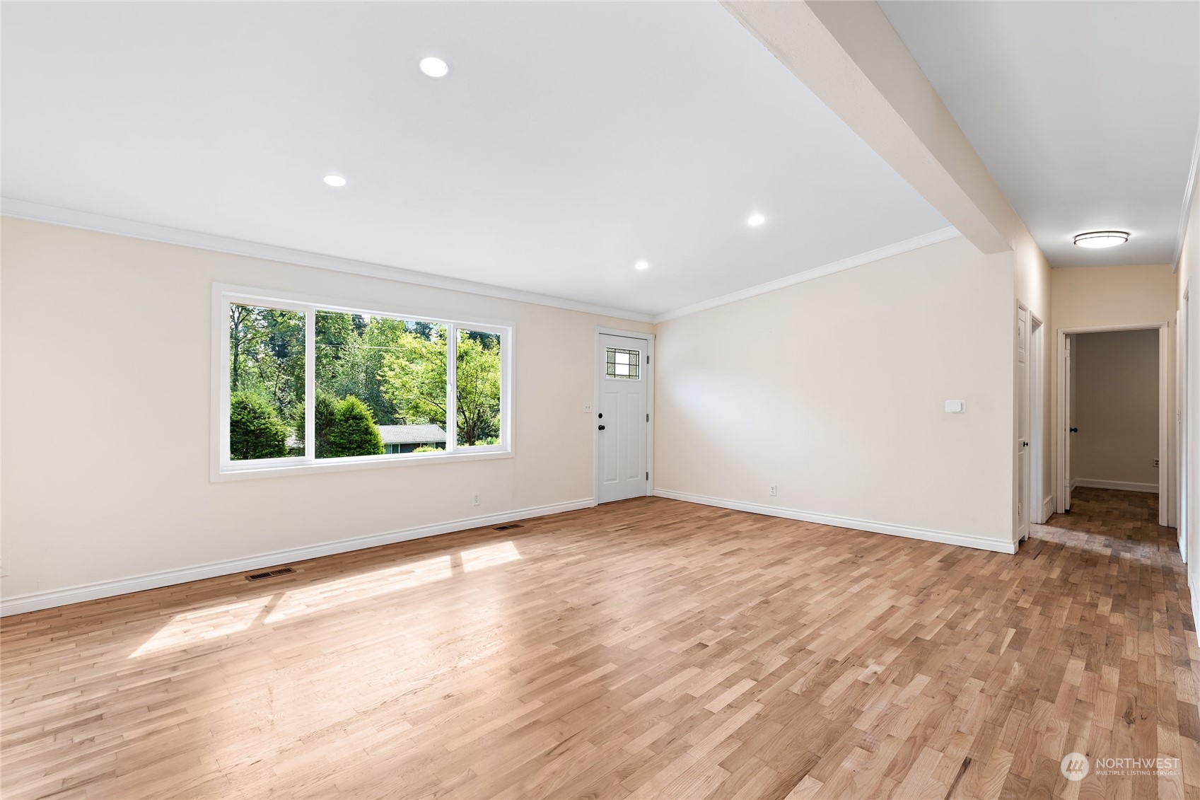 13207 178th Avenue Southeast Renton, WA 98059 - Photo 3 of 15 an empty room with wooden floor and windows