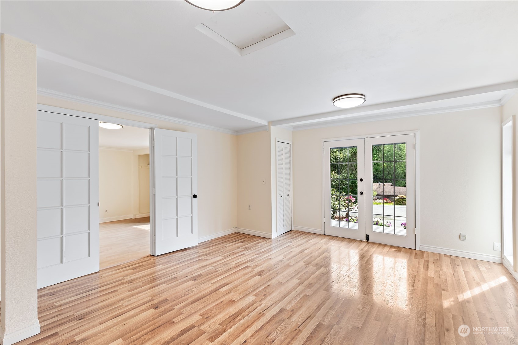 13207 178th Avenue Southeast Renton, WA 98059 - Photo 8 of 15 a view of an empty room with wooden floor and a window