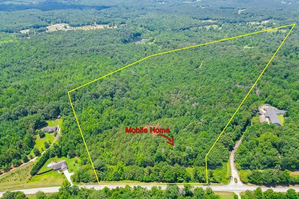 an aerial view of a houses with yard