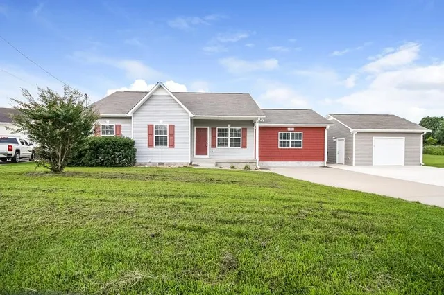 a front view of a house with a garden