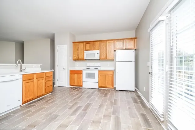 a large white kitchen with a sink