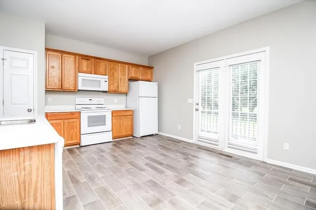 a kitchen with stainless steel appliances granite countertop a stove a sink and a refrigerator