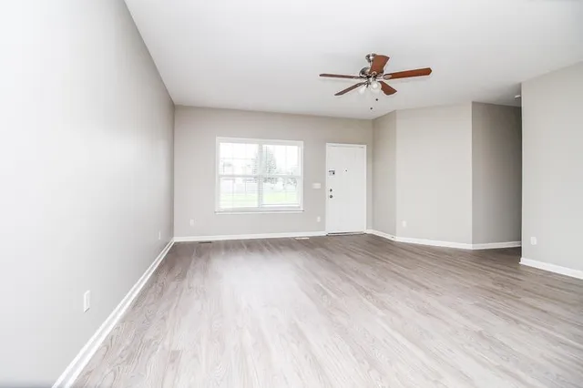 wooden floor in an empty room with a window