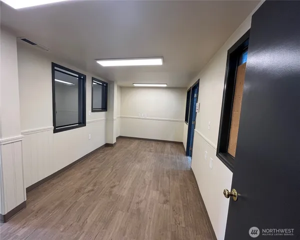 a view of a hallway with wooden floor