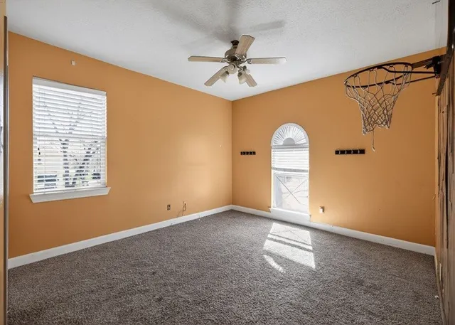 a view of a livingroom with a fireplace and a ceiling fan