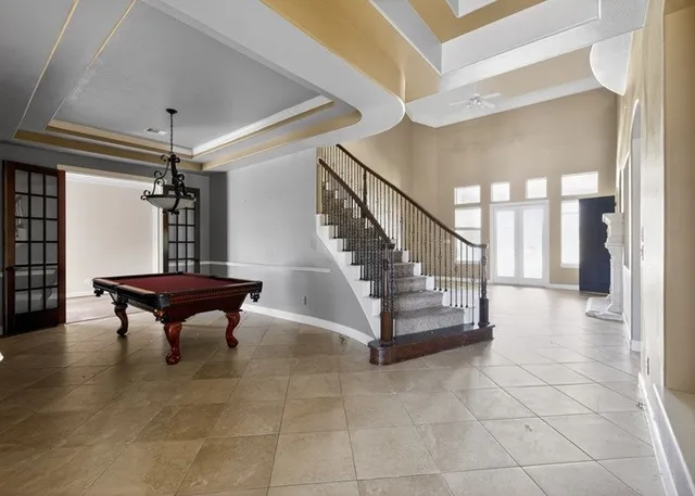 a large kitchen with a large counter top stainless steel appliances and cabinets