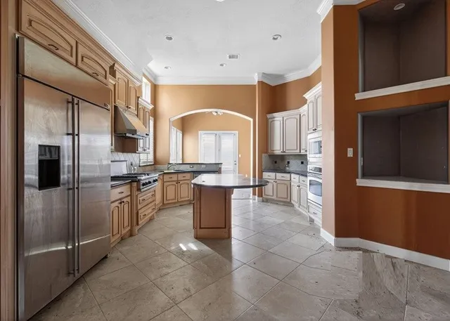 a view of a room with gym equipment and a window