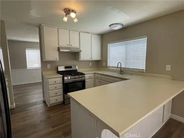 a kitchen with a stove a sink and a refrigerator