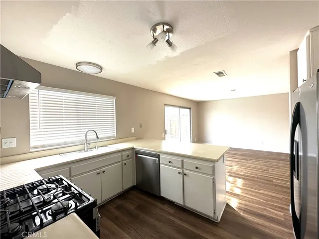 a kitchen with a sink appliances and cabinets