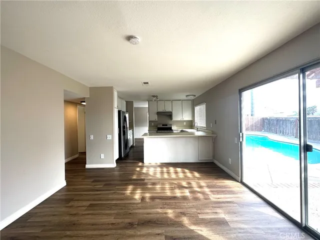 a view of kitchen with kitchen island a counter top space cabinets and stainless steel appliances