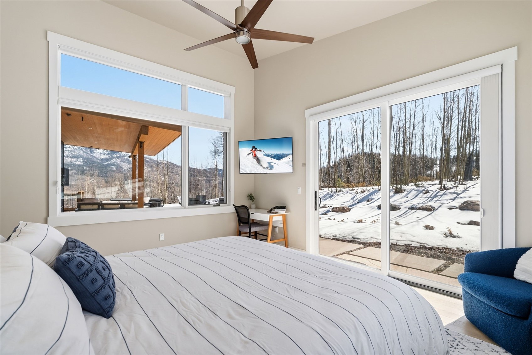 283 McKay Road Silverthorne, CO 80498 - Photo 15 of 47 Peaceful bedroom with natural light and forested surroundings.