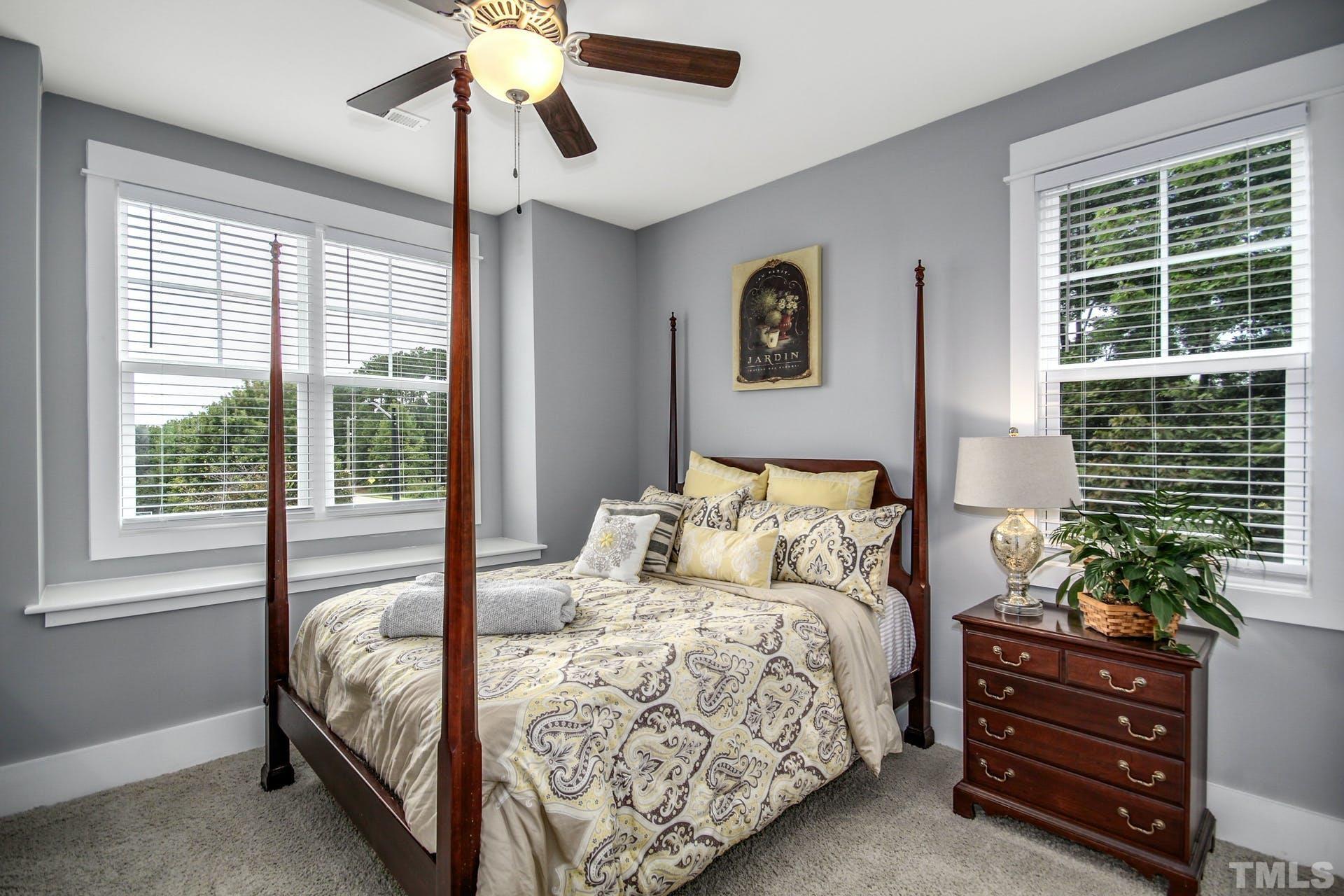 948 Flash Drive Rolesville, NC 27571 - Photo 15 of 30 a bedroom with a bed and a chandelier