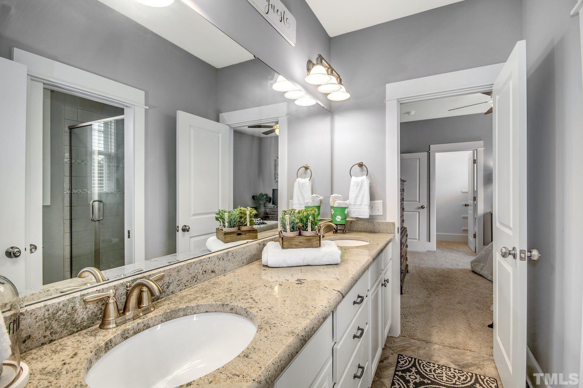 948 Flash Drive Rolesville, NC 27571 - Photo 16 of 30 a bathroom with a granite countertop double vanity sink and mirror