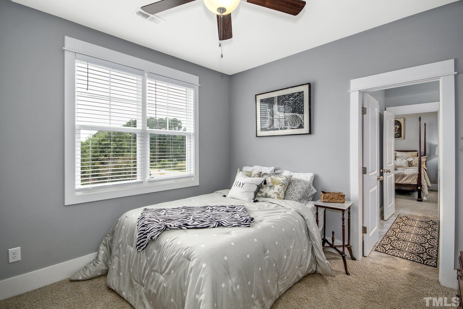 948 Flash Drive Rolesville, NC 27571 - Photo 17 of 30 a bedroom with a large bed and a chandelier