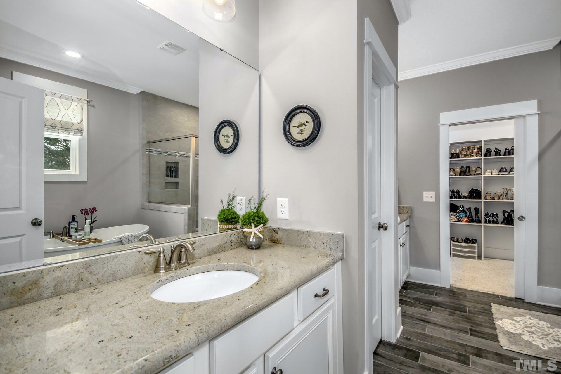 948 Flash Drive Rolesville, NC 27571 - Photo 23 of 30 a bathroom with a granite countertop sink and a mirror