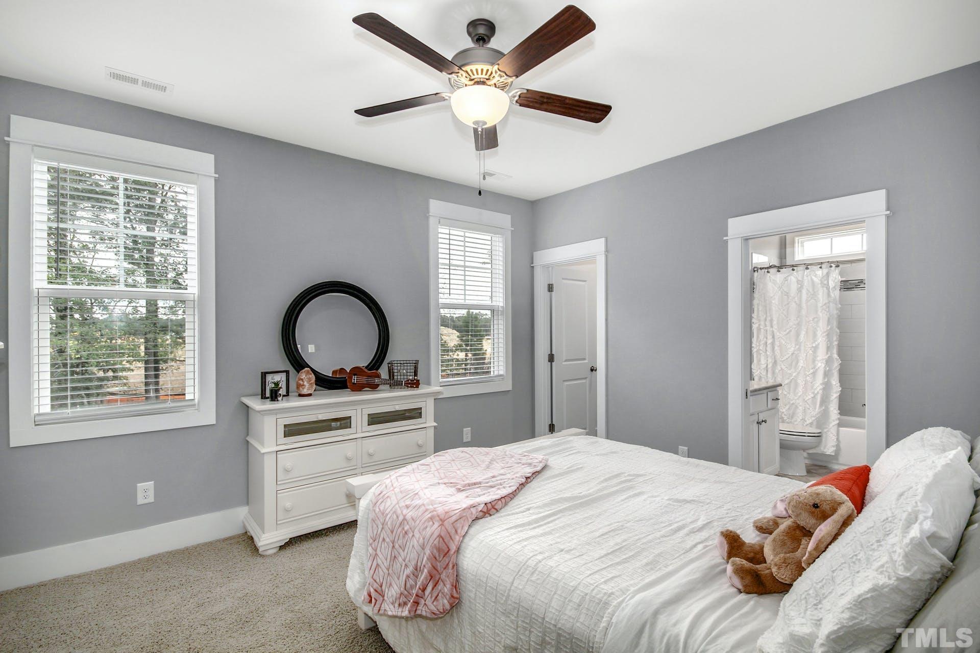 948 Flash Drive Rolesville, NC 27571 - Photo 25 of 30 a bedroom with a bed and a chandelier