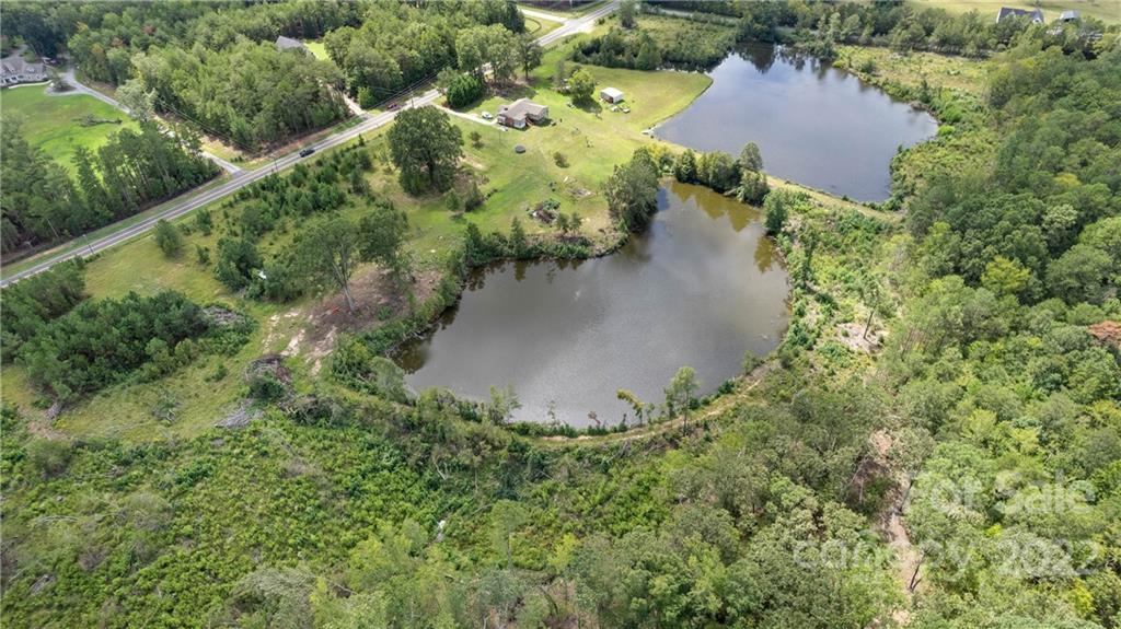 825 Sutton Spring Road York, SC 29745 - Photo 3 of 8 an aerial view of a house with a yard and lake