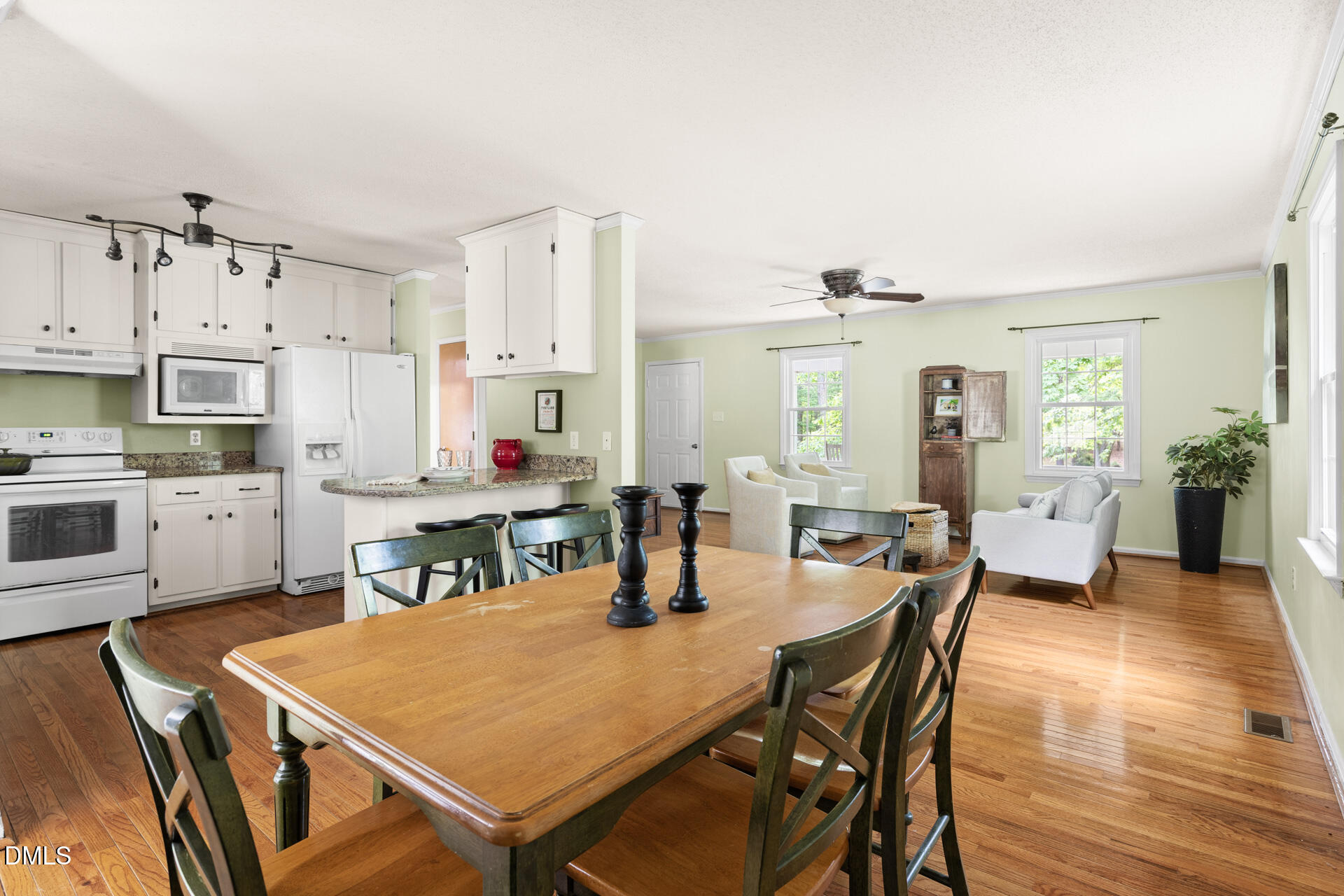 1322 Palmers Grove Church Road Hillsborough, NC 27278 - Photo 11 of 36 a open dining room with stainless steel appliances kitchen island granite countertop a dining table chairs and view living room