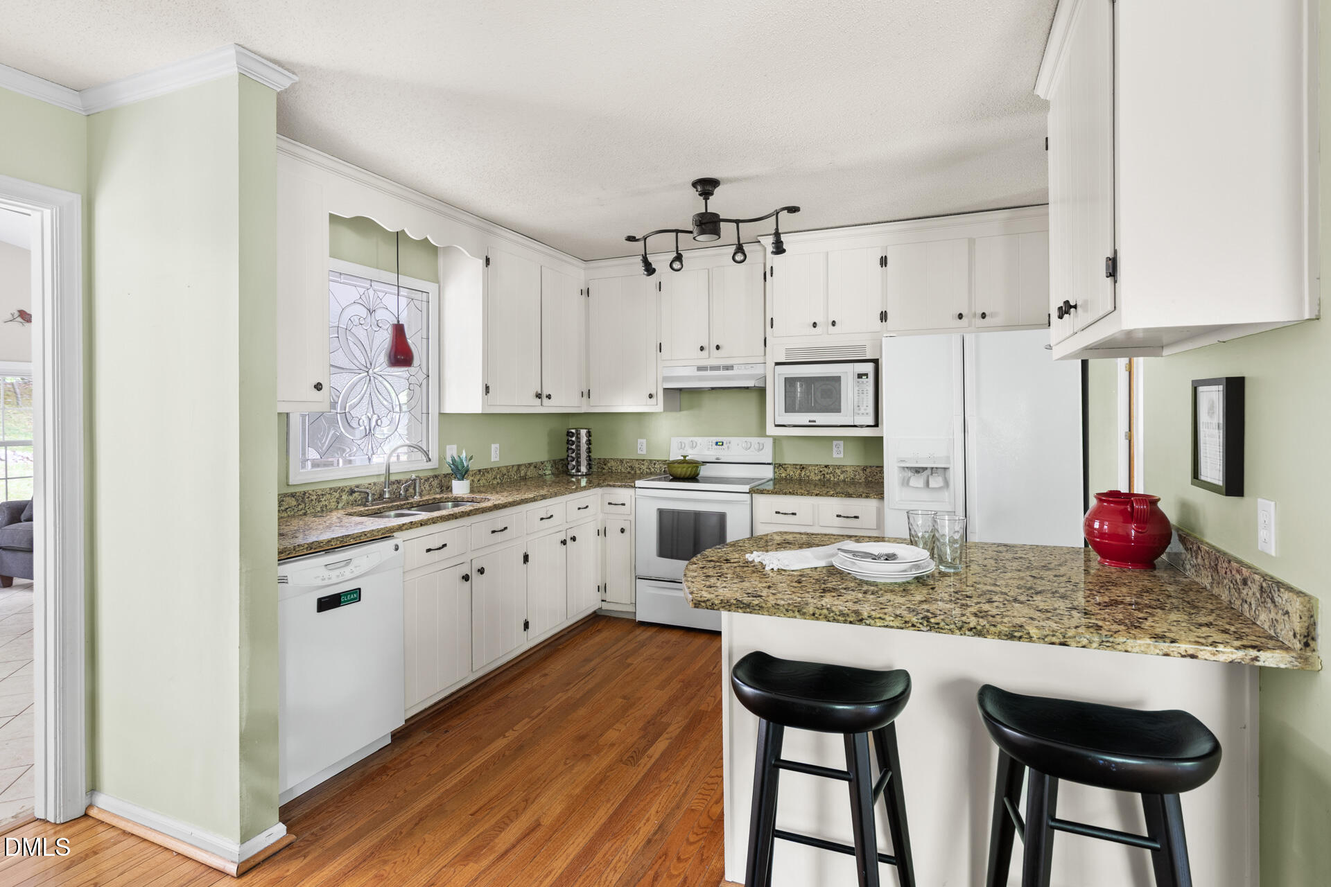 1322 Palmers Grove Church Road Hillsborough, NC 27278 - Photo 12 of 36 a kitchen with granite countertop white cabinets and white appliances