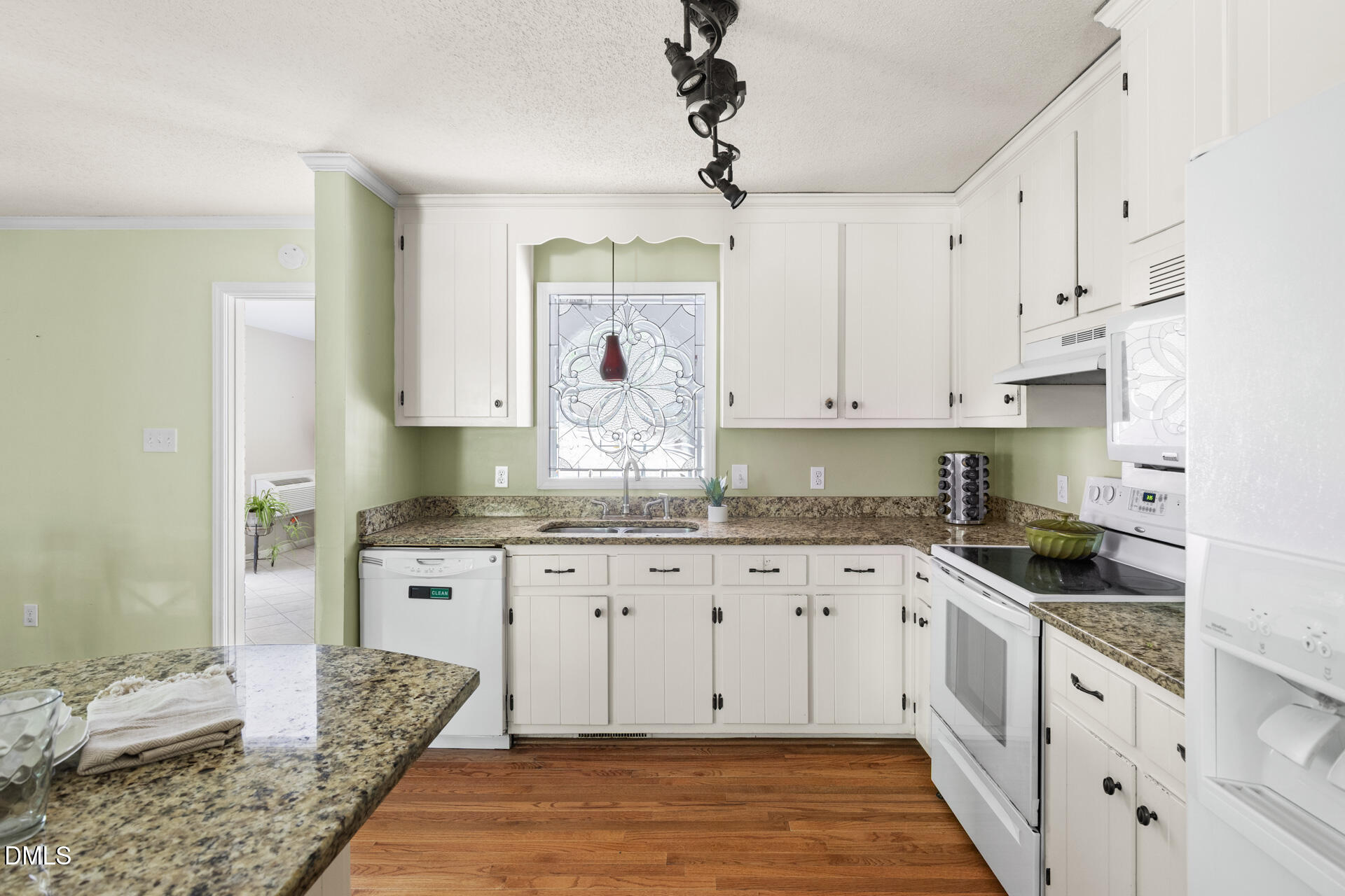 1322 Palmers Grove Church Road Hillsborough, NC 27278 - Photo 13 of 36 a kitchen with granite countertop white cabinets and white appliances