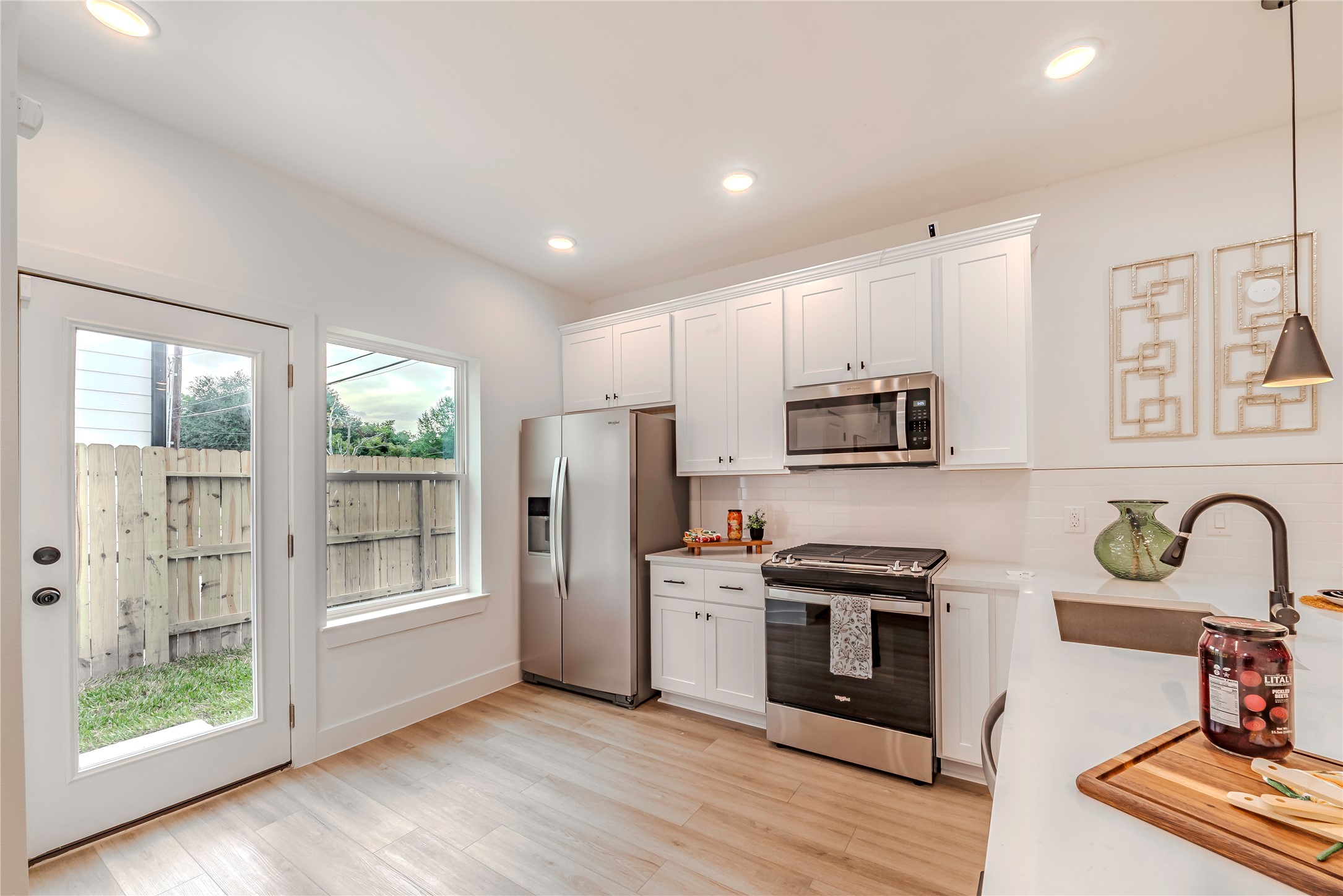 9527-9529 Beckley Street Houston, TX 77088 - Photo 14 of 14 a kitchen with stainless steel appliances granite countertop a refrigerator and a stove top oven