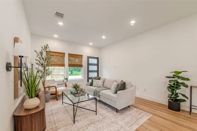 a living room with furniture potted plant and a window