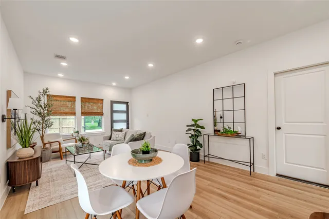 a living room with furniture kitchen and a large window