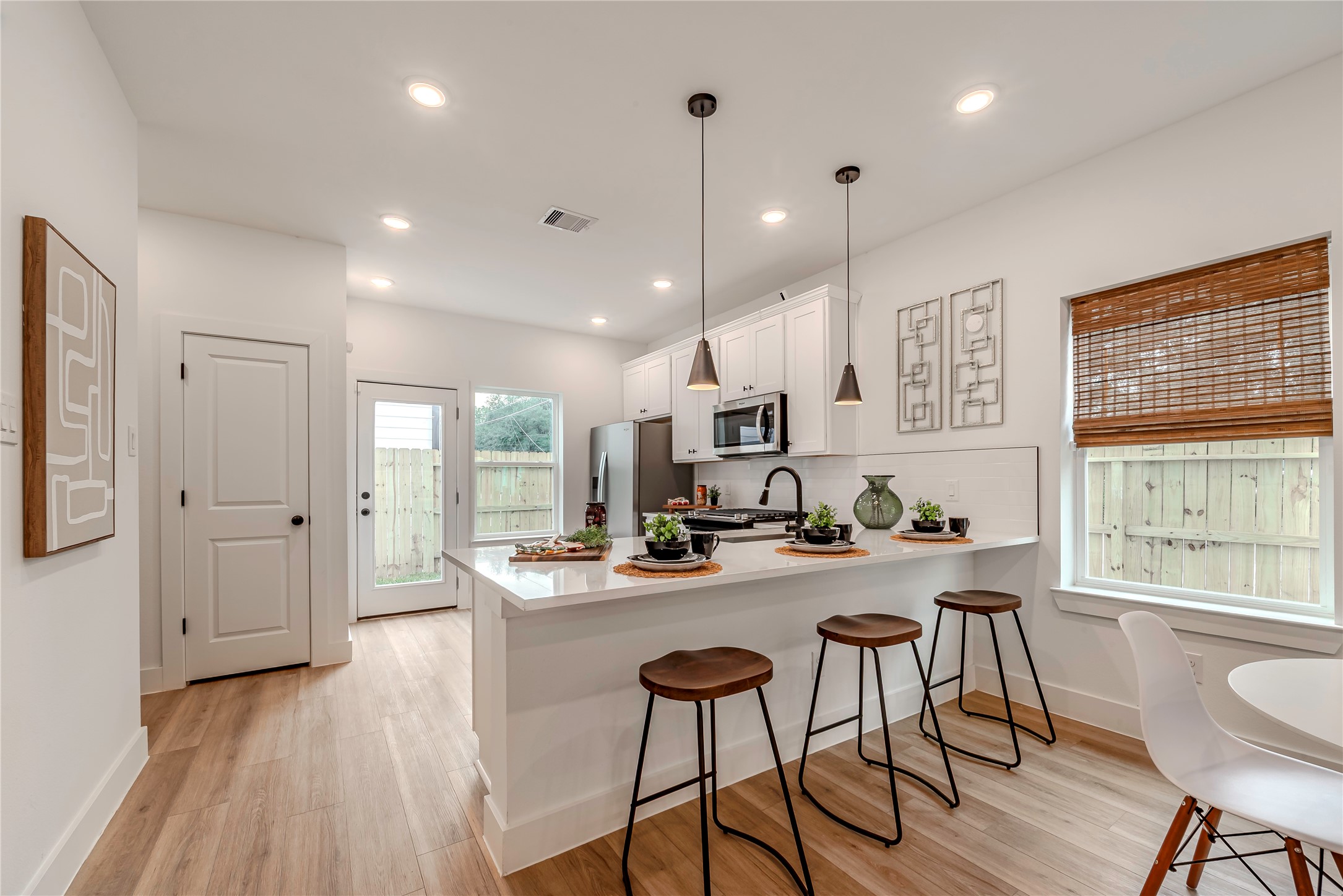 9527-9529 Beckley Street Houston, TX 77088 - Photo 7 of 14 a dining room with stainless steel appliances furniture a window and a kitchen view