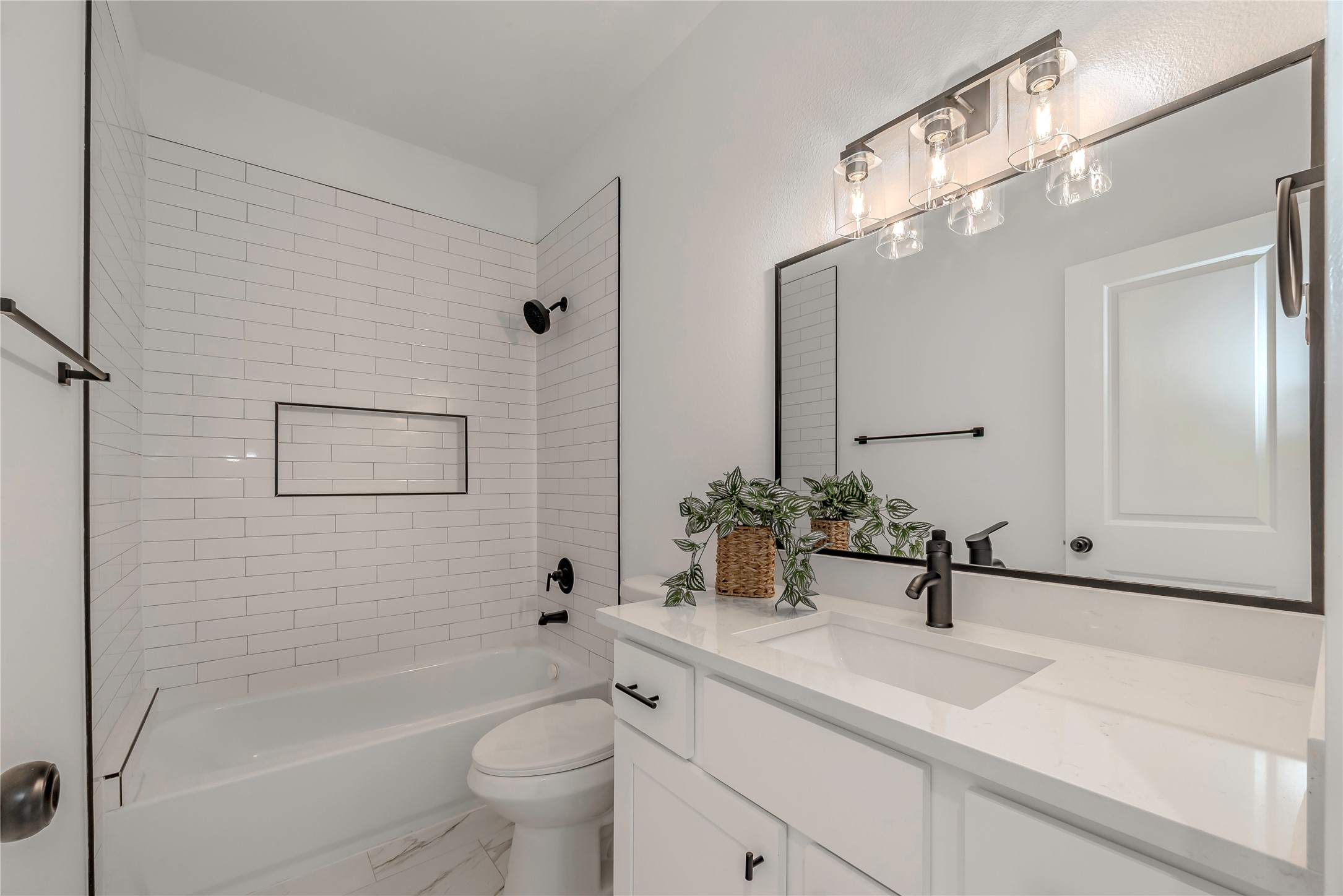 9527-9529 Beckley Street Houston, TX 77088 - Photo 10 of 14 a bathroom with a sink a toilet and shower