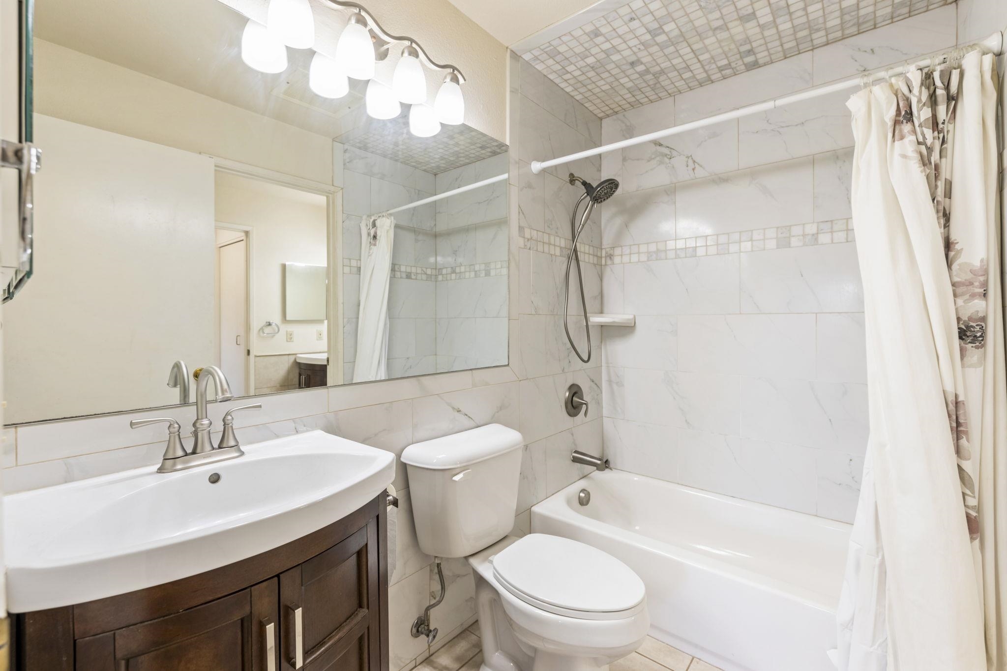 140 Uwapo Road, Unit 18203 Kihei, HI 96753 - Photo 12 of 40 a bathroom with a sink vanity mirror and toilet