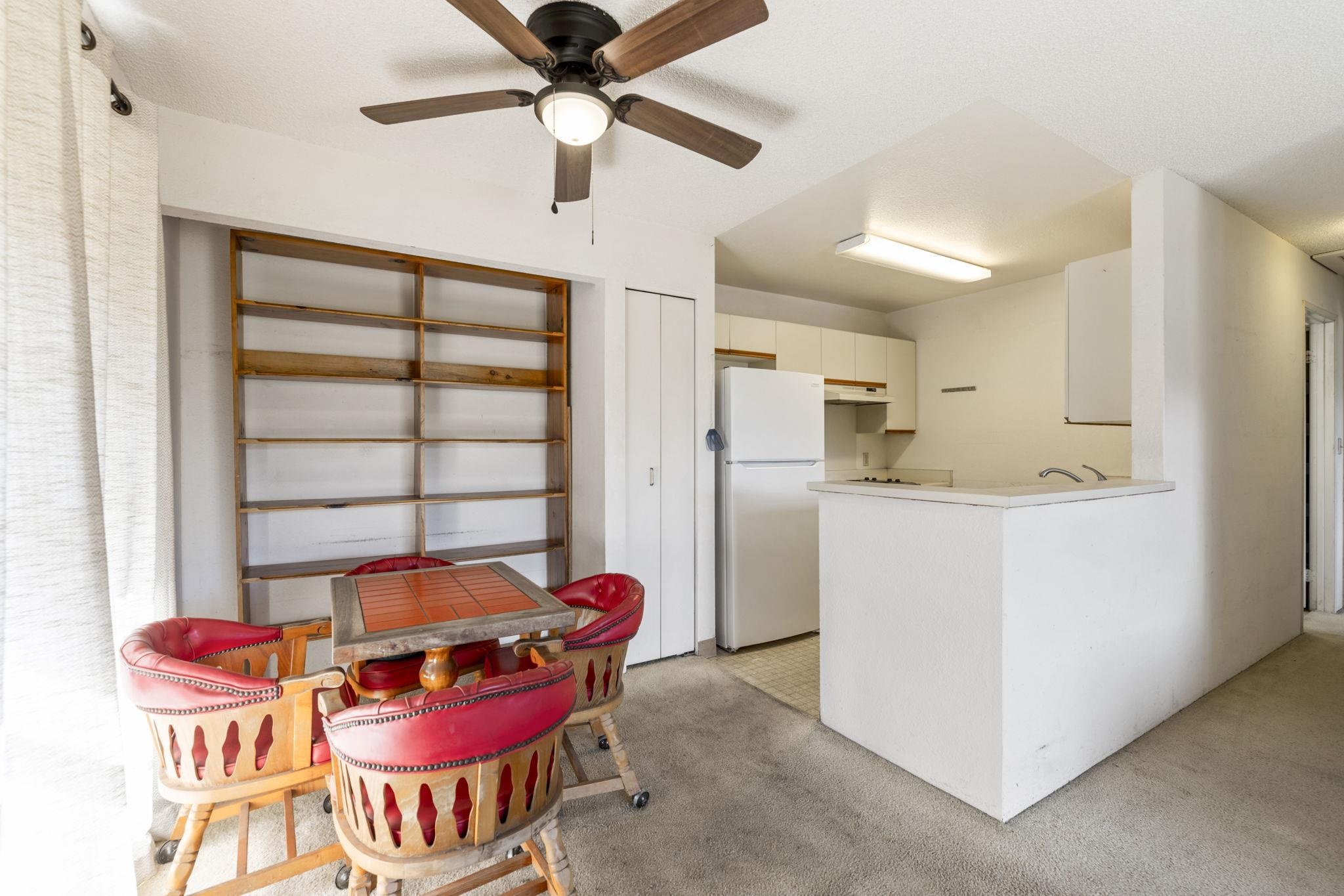 140 Uwapo Road, Unit 18203 Kihei, HI 96753 - Photo 2 of 40 a kitchen with stainless steel appliances kitchen island granite countertop a refrigerator and a dining table