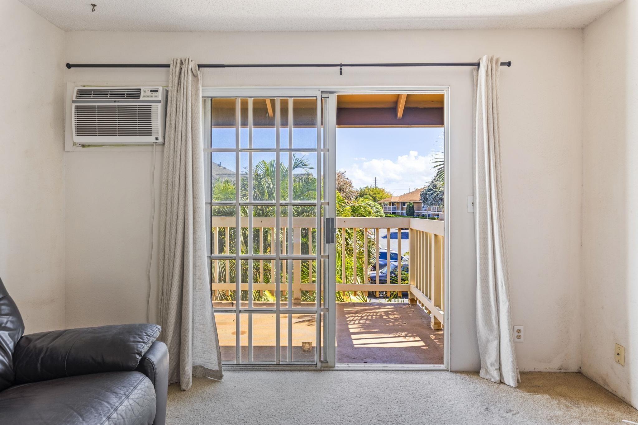 140 Uwapo Road, Unit 18203 Kihei, HI 96753 - Photo 27 of 40 a view of front door with furniture and floor to ceiling window