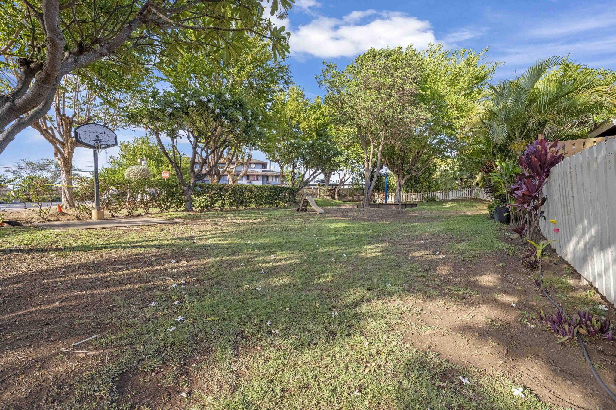 140 Uwapo Road, Unit 18203 Kihei, HI 96753 - Photo 39 of 40 a backyard of a house with lots of green space and fountain