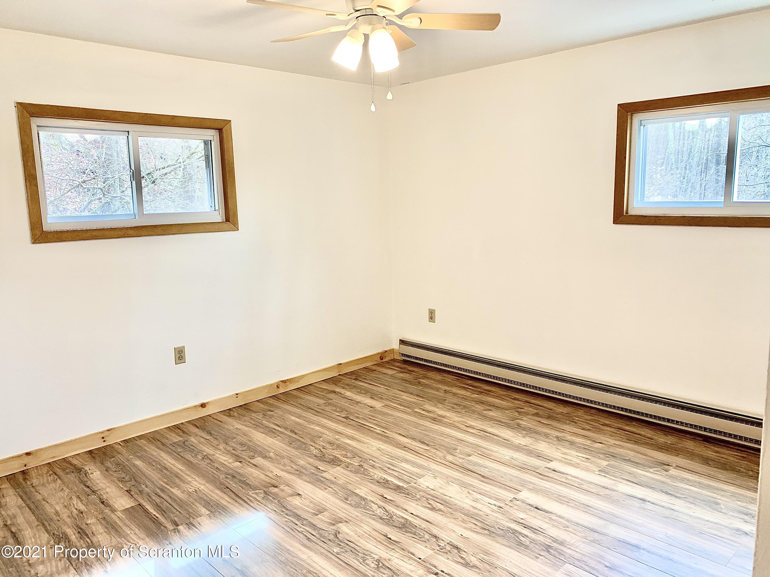 3886 Button Road Hop Bottom, PA 18824 - Photo 15 of 29 a view of an empty room and wooden floor