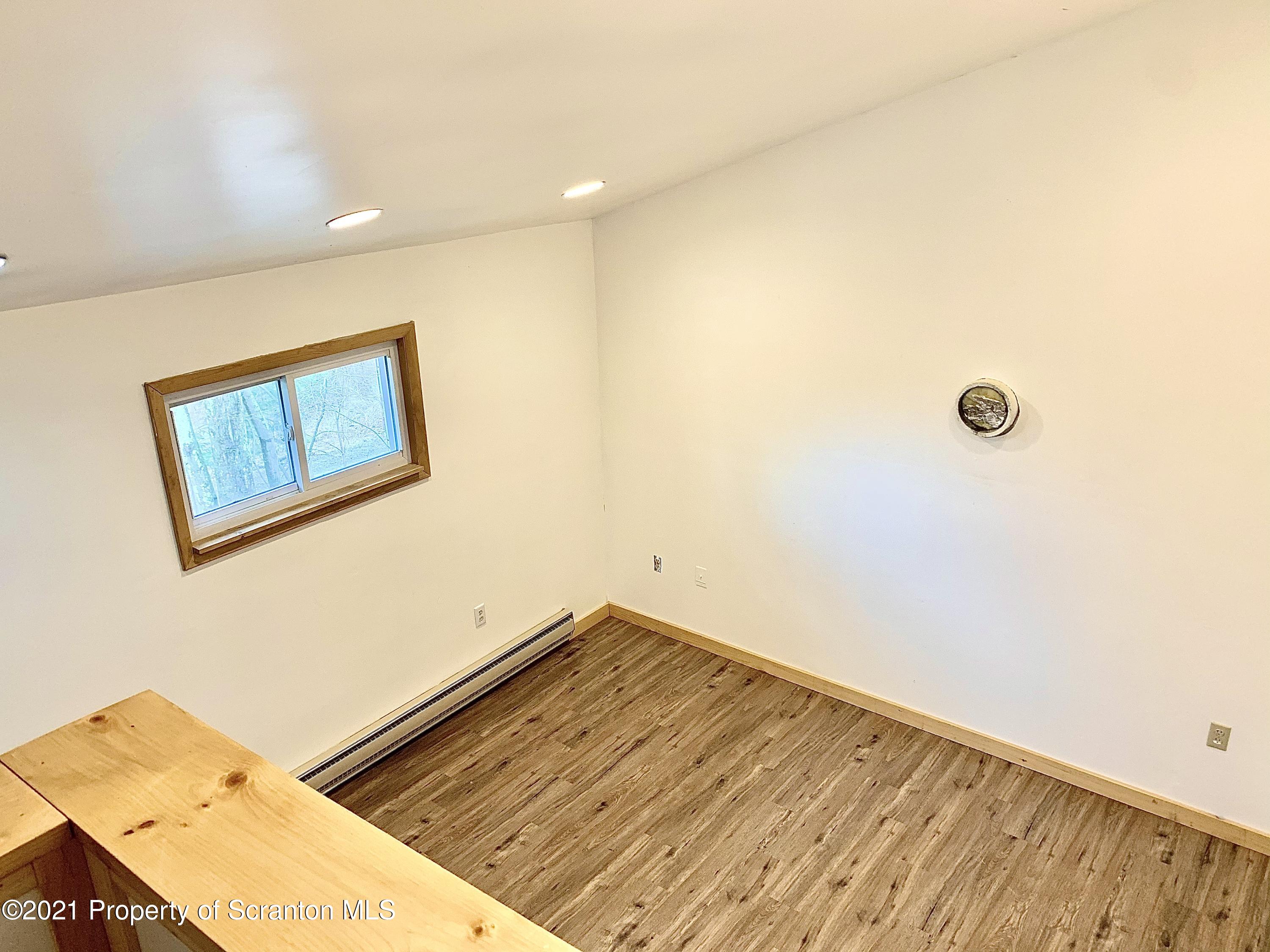 3886 Button Road Hop Bottom, PA 18824 - Photo 5 of 29 a view of a room with a wooden floor