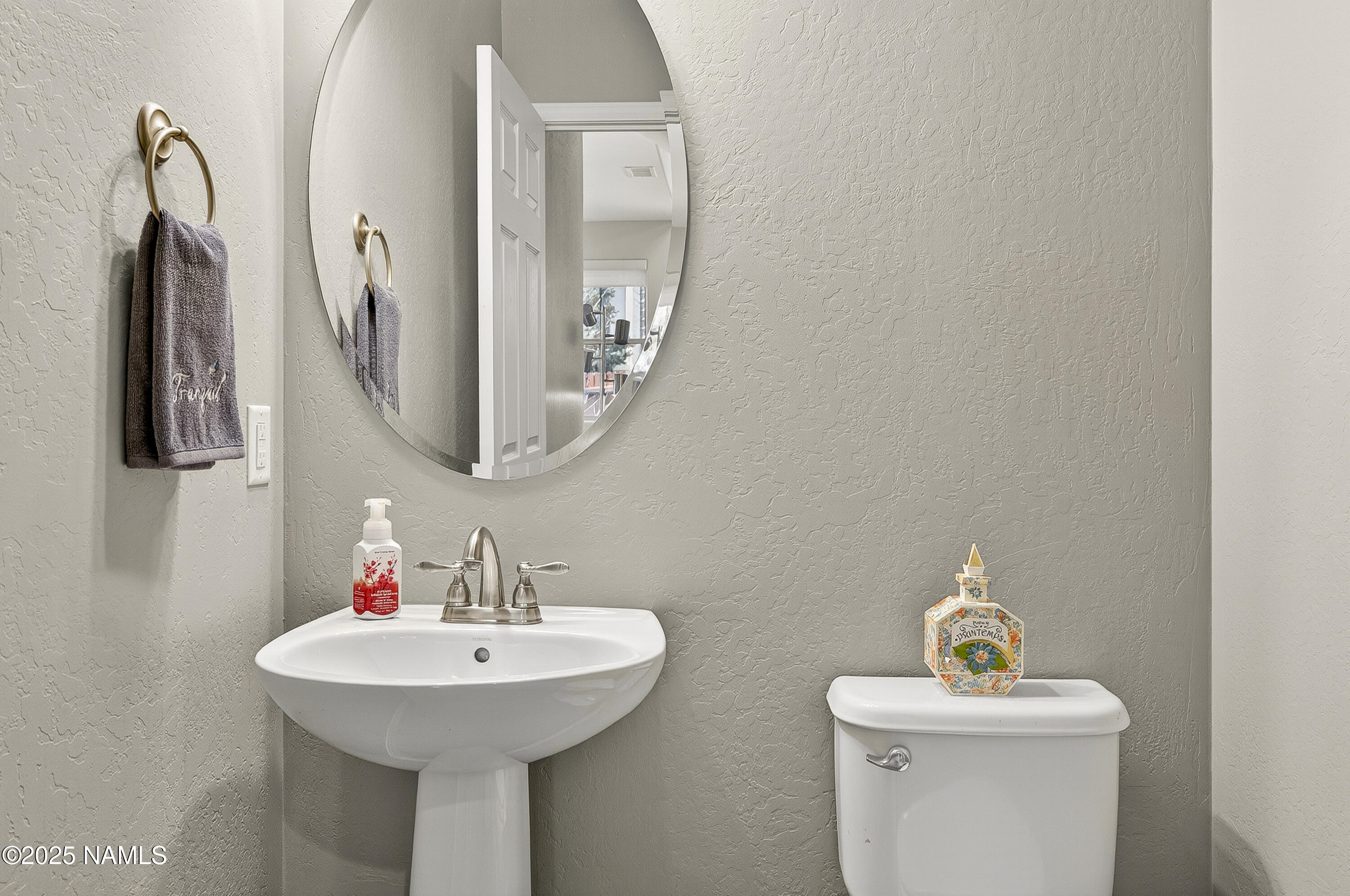 3143 East Cold Springs Trail Flagstaff, AZ 86004 - Photo 13 of 33 a bathroom with a sink and a mirror