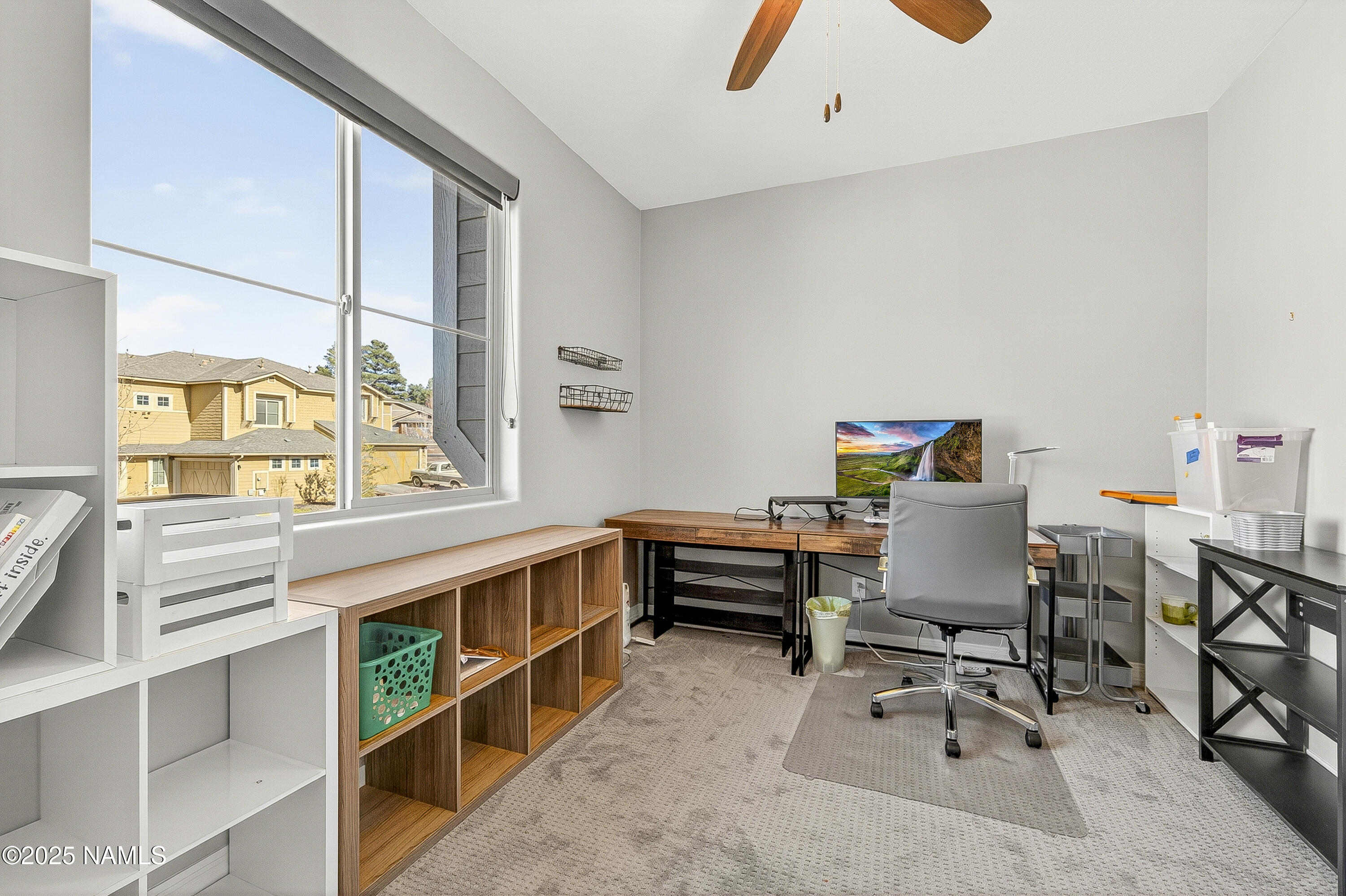 3143 East Cold Springs Trail Flagstaff, AZ 86004 - Photo 22 of 33 a view of a workspace with furniture and a window