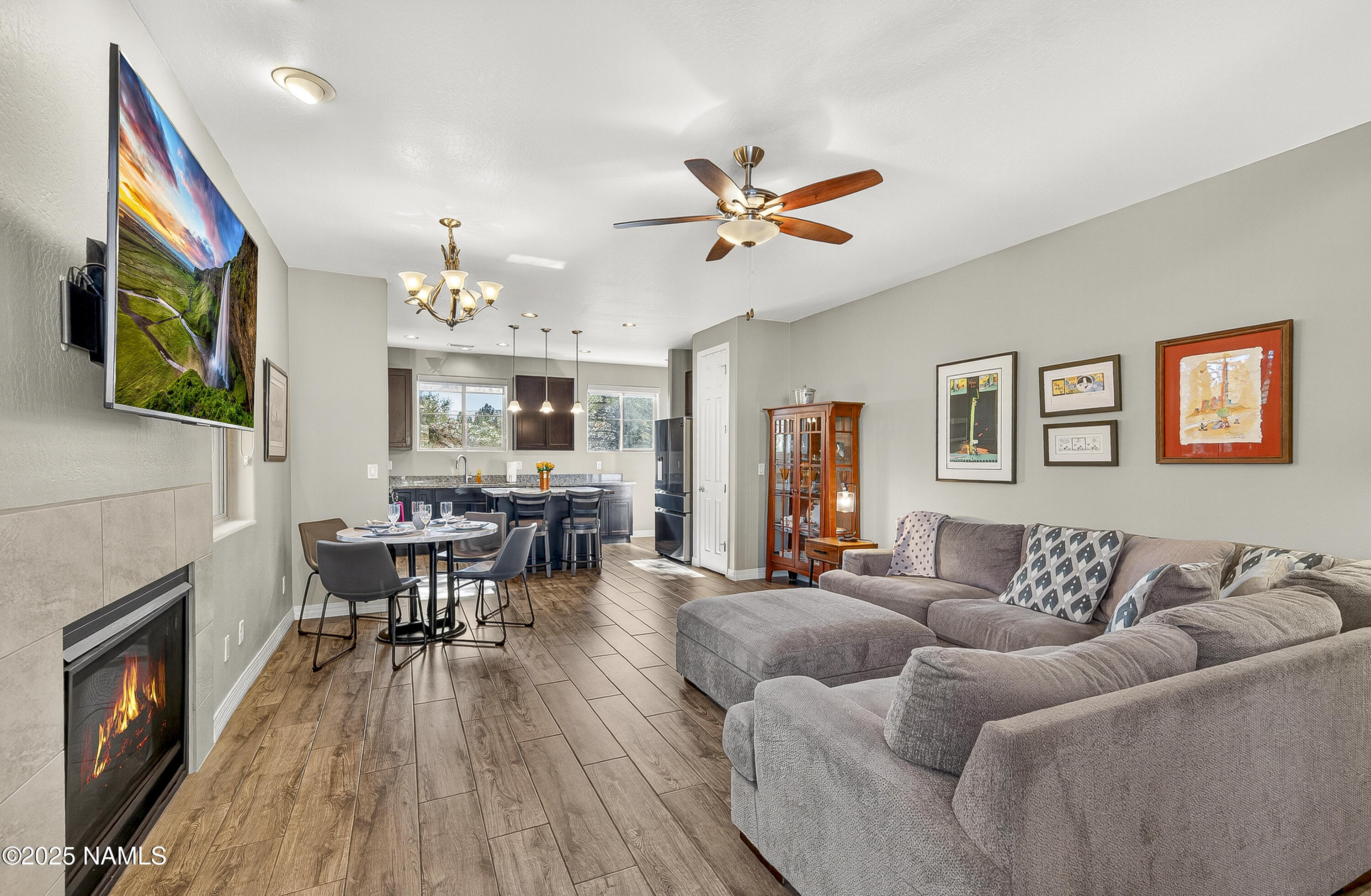 3143 East Cold Springs Trail Flagstaff, AZ 86004 - Photo 3 of 33 a living room with furniture a fireplace and a flat screen tv