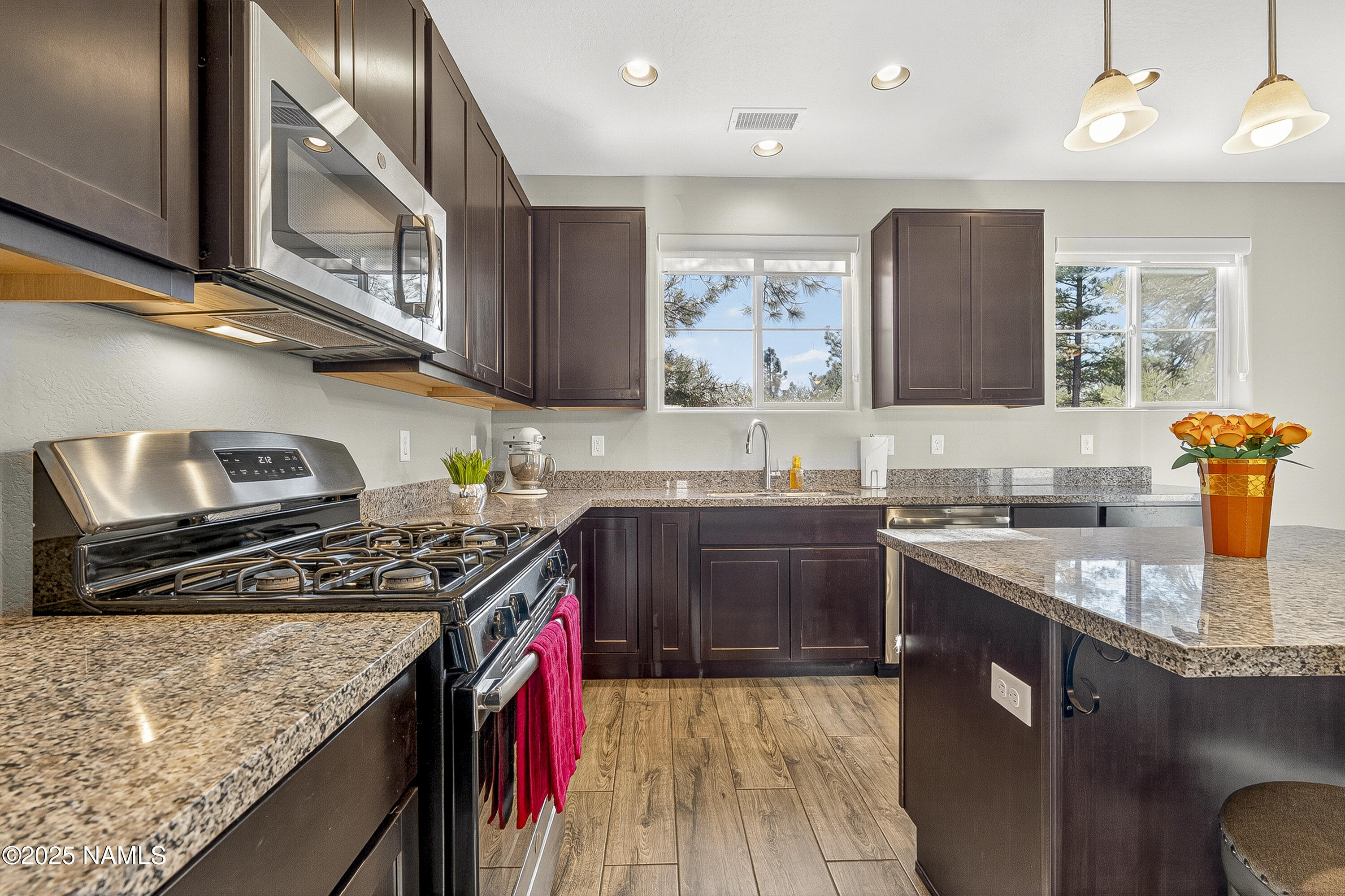 3143 East Cold Springs Trail Flagstaff, AZ 86004 - Photo 6 of 33 a kitchen with stainless steel appliances granite countertop a sink stove and cabinets