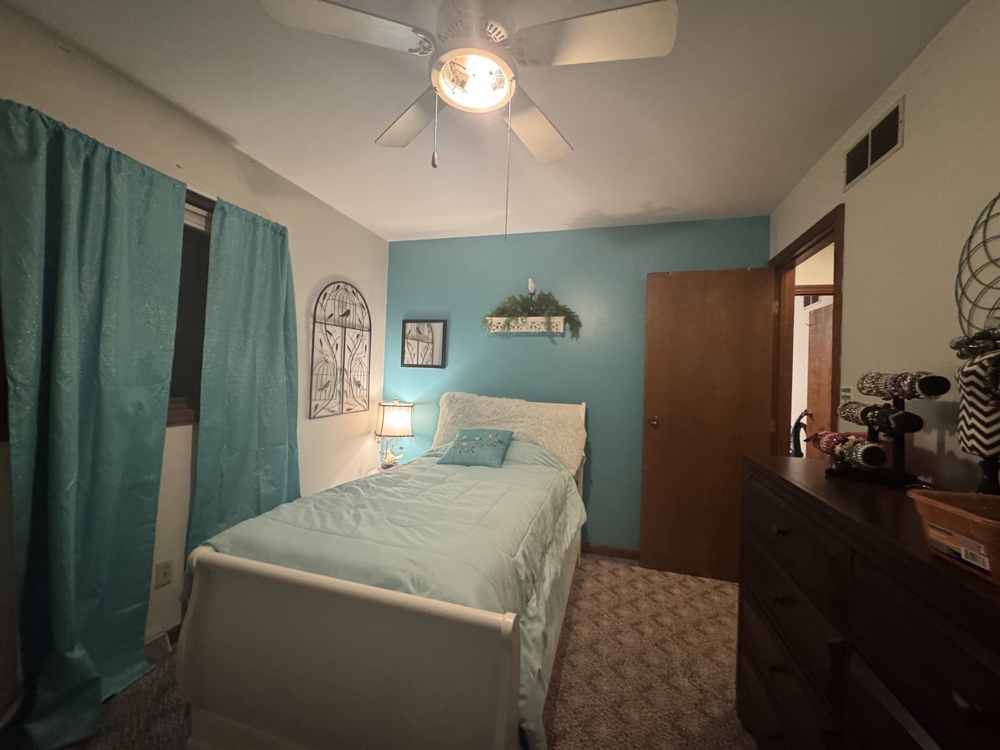 21 Colonial Drive Clinton, IL 61727 - Photo 30 of 40 a bedroom with a bed and a chandelier