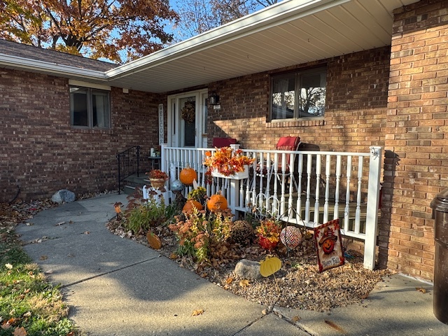 21 Colonial Drive Clinton, IL 61727 - Photo 8 of 40 a view of a porch with a table and chairs