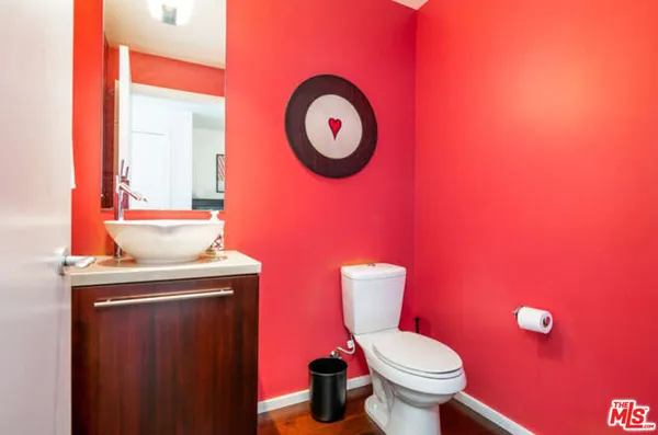 a bathroom with a toilet a sink and a mirror