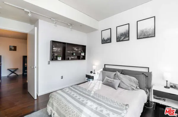 a bedroom with a large bed and a tv