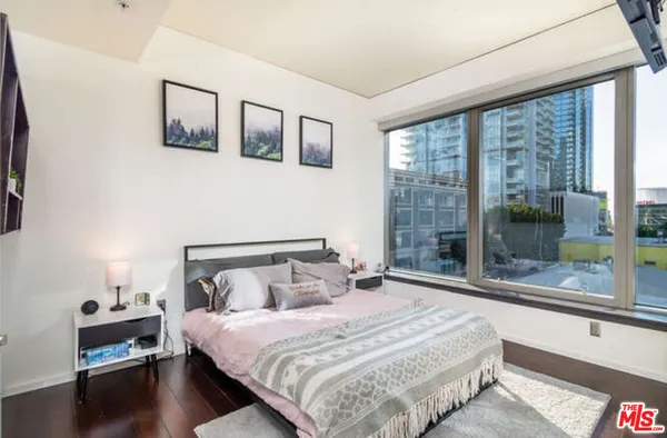 a bedroom with a large bed and a large window