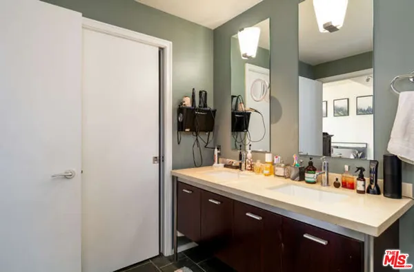 a bathroom with a sink vanity granite and a mirror