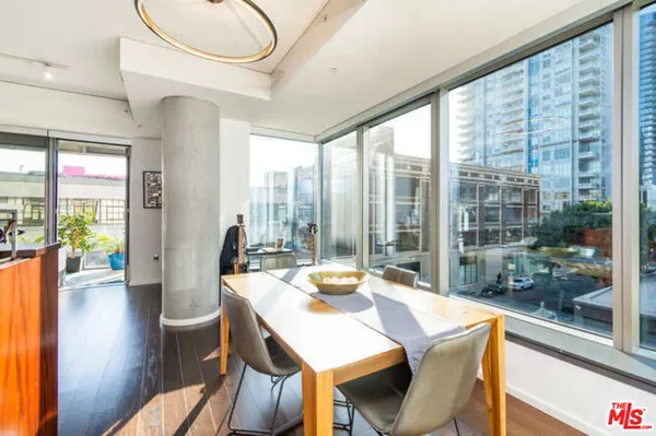 a view of a dining room with furniture window and wooden floor