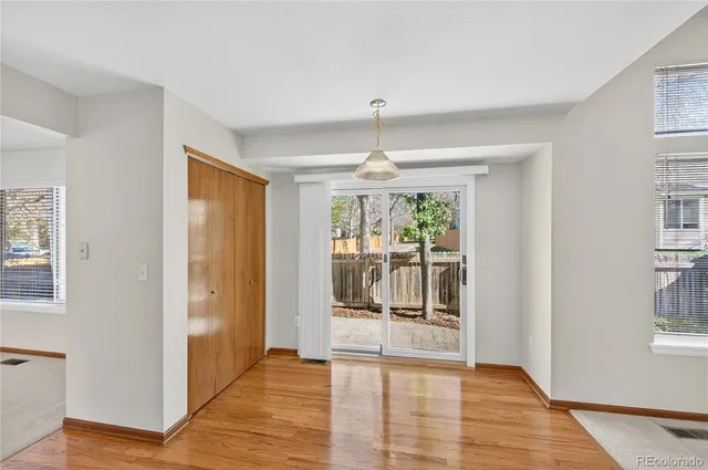 a view of a living room with furniture and wooden floor